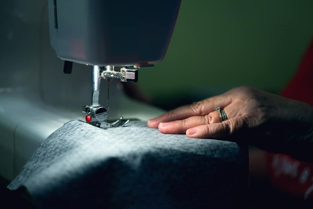 Close-up of hands working at a sewing machine