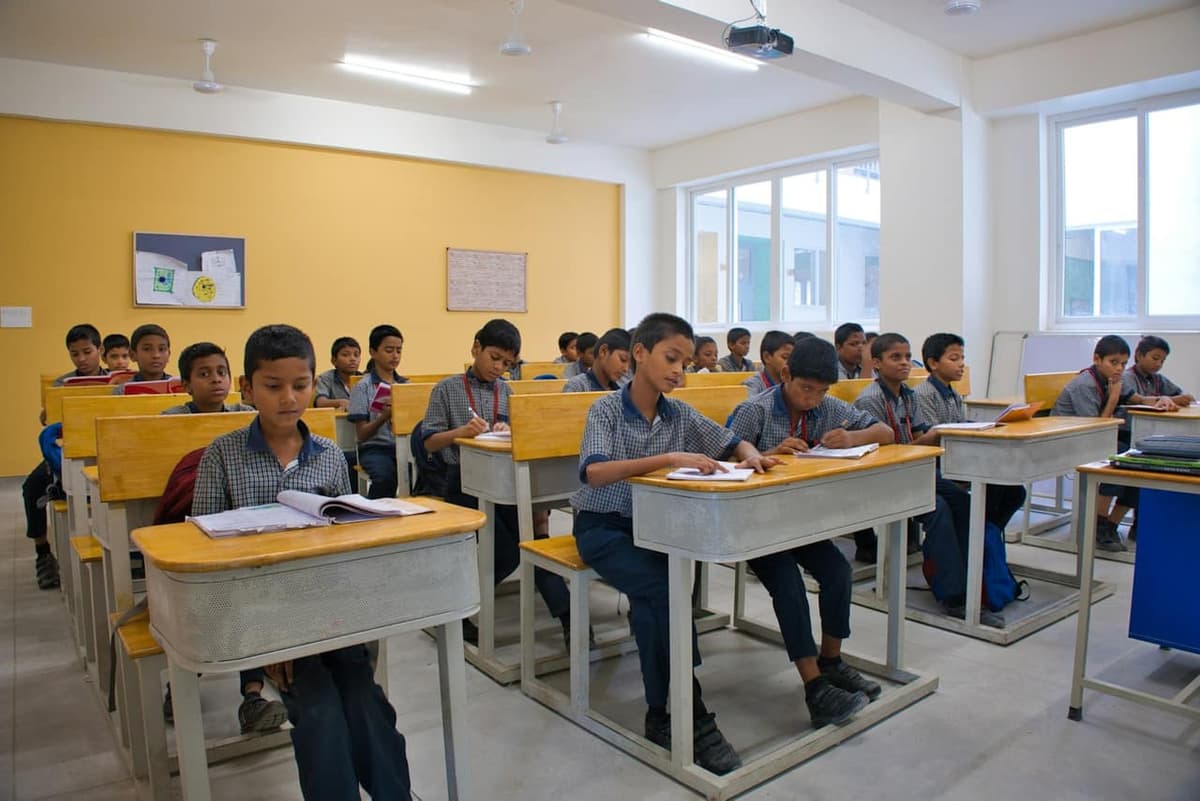 Students studying at desks in an Indian classroom