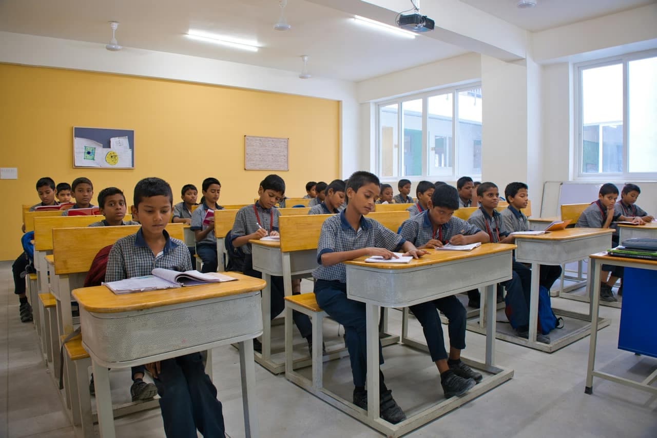 Students studying at desks in a classroom