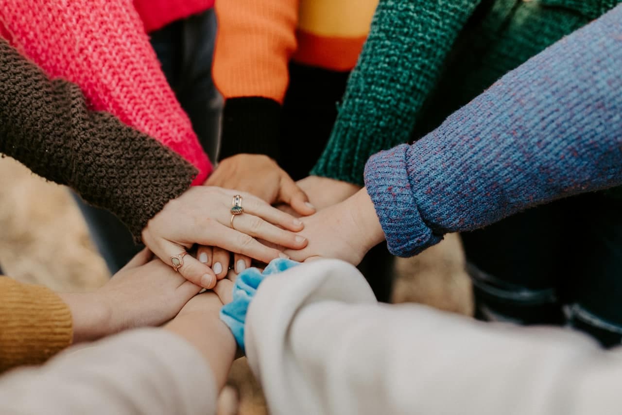 Volunteers stacking hands together